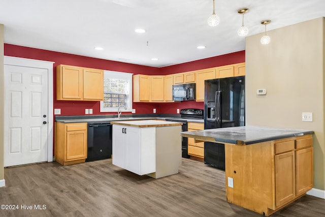 kitchen with black appliances, a kitchen island, wood-type flooring, and pendant lighting