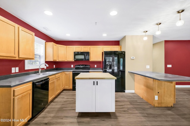 kitchen with sink, decorative light fixtures, a kitchen island, and black appliances