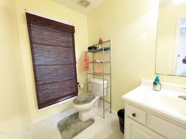 bathroom featuring vanity, tile patterned floors, and toilet