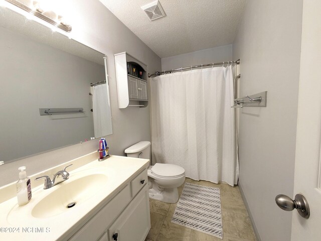 117 Longwood Dr, Stella, NC 28582 - bathroom with a textured ceiling, vanity, and toilet