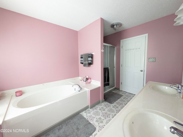 bathroom with vanity, a textured ceiling, and plus walk in shower