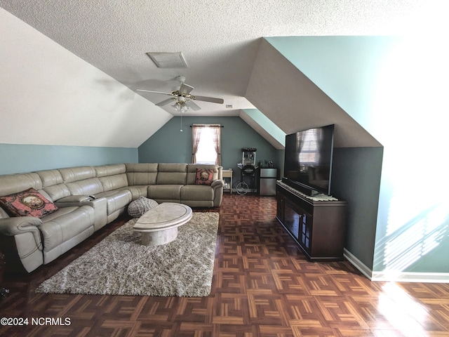 living room with dark parquet floors, ceiling fan, a textured ceiling, and lofted ceiling