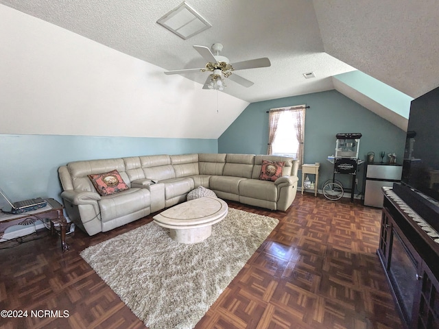 living room featuring dark parquet flooring, lofted ceiling, a textured ceiling, and ceiling fan