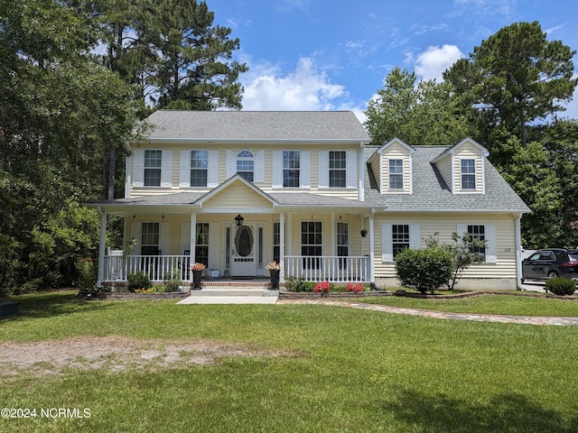 117 Longwood Dr, Stella, NC 28582 - colonial house featuring covered porch, a shingled roof, and a front yard