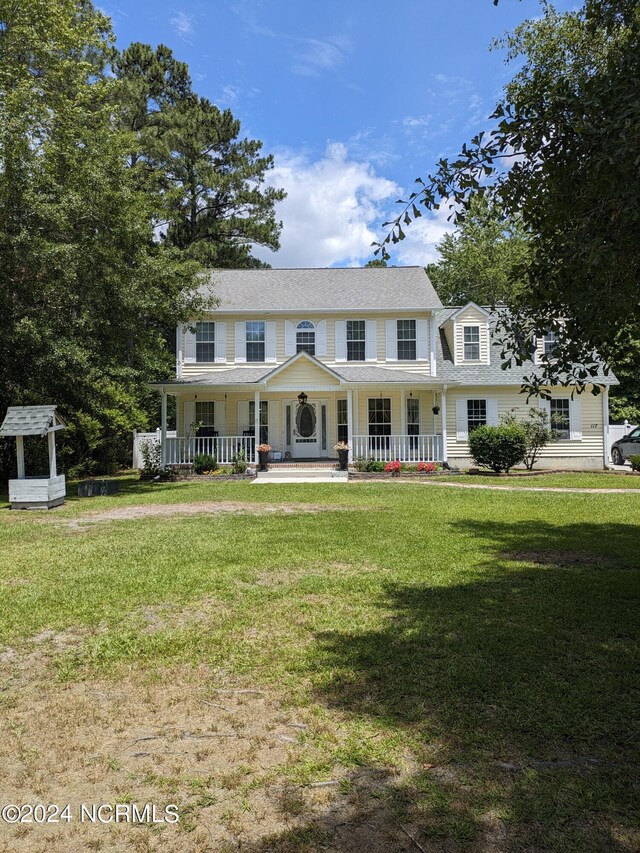 117 Longwood Dr, Stella, NC 28582 - colonial house with covered porch, a front lawn, and a shingled roof