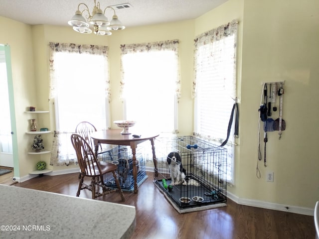 117 Longwood Dr, Stella, NC 28582 - dining room with a chandelier, wood finished floors, healthy amount of natural light, and baseboards