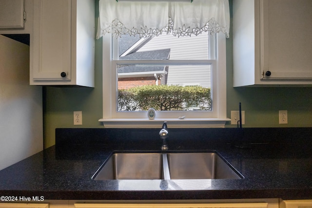 kitchen with white cabinetry and sink