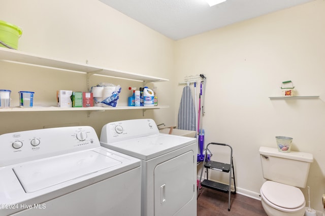 clothes washing area with washing machine and dryer, sink, and dark hardwood / wood-style floors