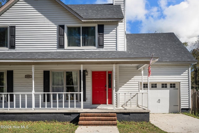 view of front facade with a porch and a garage