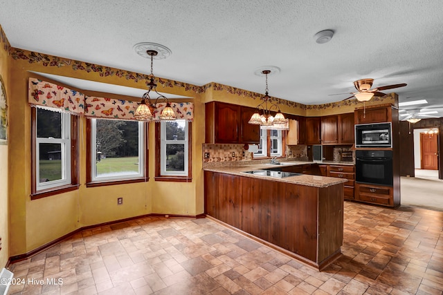 kitchen featuring tasteful backsplash, kitchen peninsula, pendant lighting, and black appliances