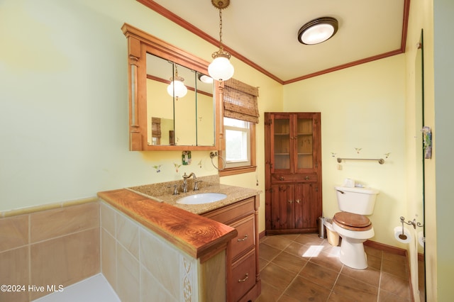 bathroom featuring vanity, lofted ceiling, tile patterned flooring, toilet, and ornamental molding