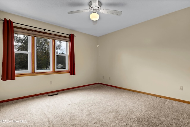 empty room featuring carpet flooring and ceiling fan