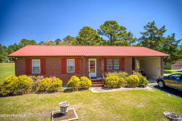 ranch-style home featuring a carport and a front yard