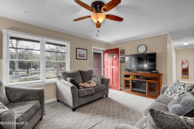 living room with a textured ceiling, carpet floors, and ceiling fan