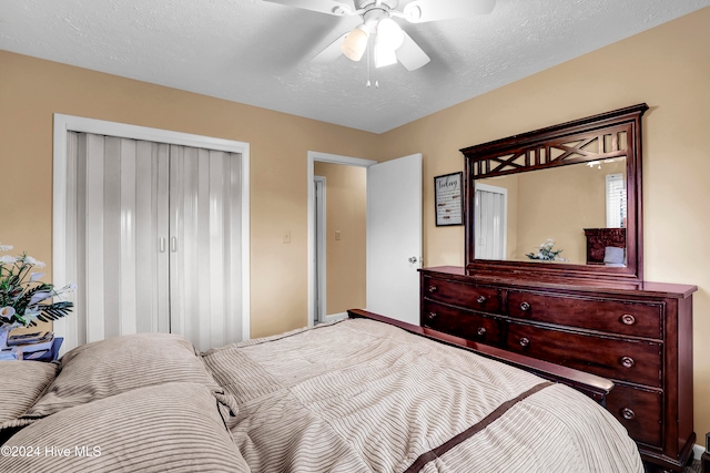 bedroom with a textured ceiling and ceiling fan