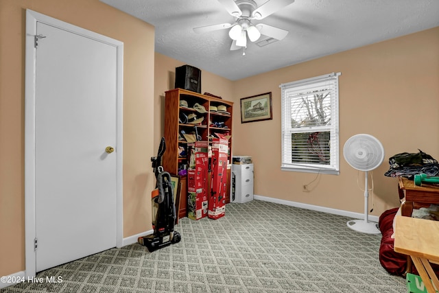 miscellaneous room featuring light carpet, a textured ceiling, and ceiling fan