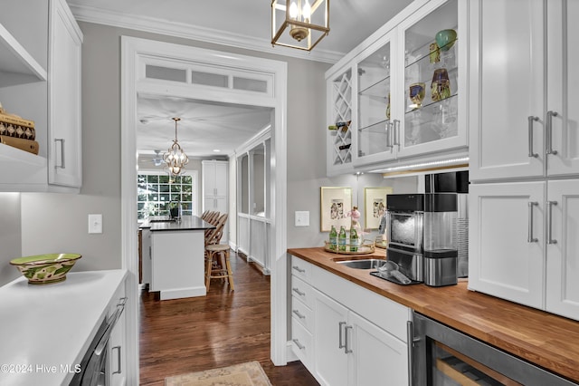 1831 Hawthorne Rd, Wilmington, NC 28403 - kitchen with wooden counters, ornamental molding, a chandelier, white cabinets, and beverage cooler