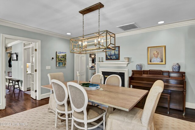 living area featuring a barn door, crown molding, ceiling fan, and dark hardwood / wood-style floors