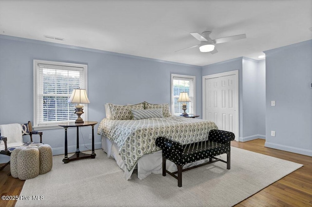 1831 Hawthorne Rd, Wilmington, NC 28403 - bedroom featuring ornamental molding, a closet, baseboards, wood finished floors, and a ceiling fan