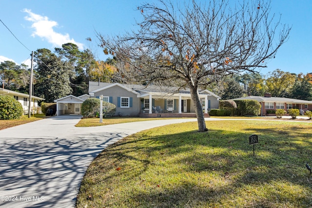 ranch-style home with covered porch and a front lawn