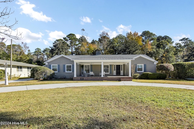 1831 Hawthorne Rd, Wilmington, NC 28403 - ranch-style house featuring covered porch, a front lawn, and a chimney
