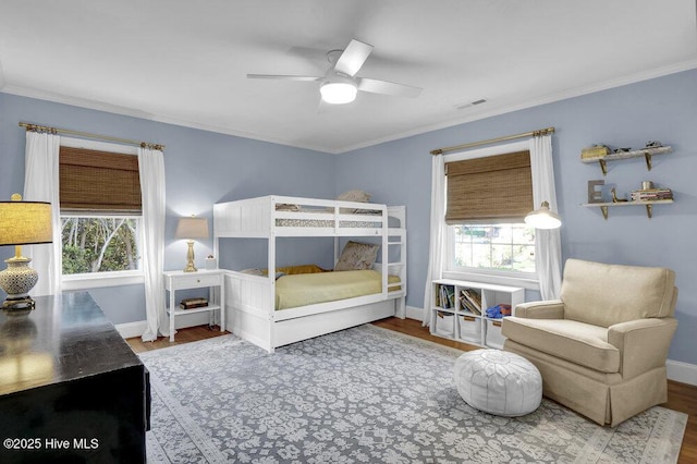 1831 Hawthorne Rd, Wilmington, NC 28403 - bedroom with wood finished floors, multiple windows, baseboards, and crown molding