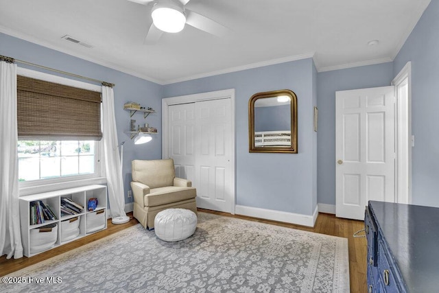 1831 Hawthorne Rd, Wilmington, NC 28403 - living area featuring wood finished floors, ceiling fan, baseboards, and crown molding