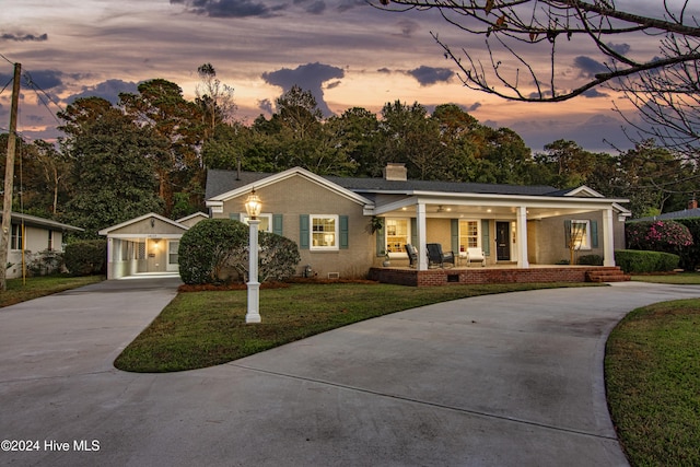 1831 Hawthorne Rd, Wilmington, NC 28403 - ranch-style home with concrete driveway, a porch, a chimney, a lawn, and crawl space
