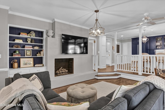 1831 Hawthorne Rd, Wilmington, NC 28403 - living area featuring a chandelier, wood finished floors, crown molding, a ceiling fan, and a fireplace with raised hearth