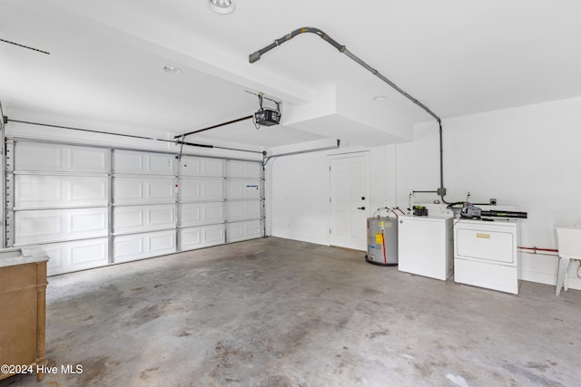 garage with independent washer and dryer, electric water heater, and a garage door opener