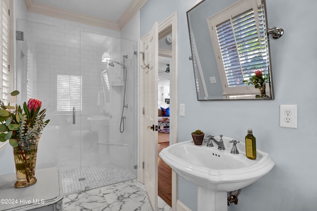 bathroom featuring crown molding, ceiling fan, and an enclosed shower