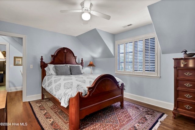 bedroom with ceiling fan, lofted ceiling, and dark wood-type flooring