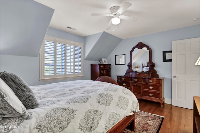 bedroom with ceiling fan, dark hardwood / wood-style flooring, and lofted ceiling