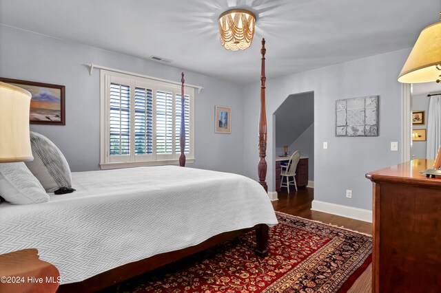 bedroom with dark hardwood / wood-style floors