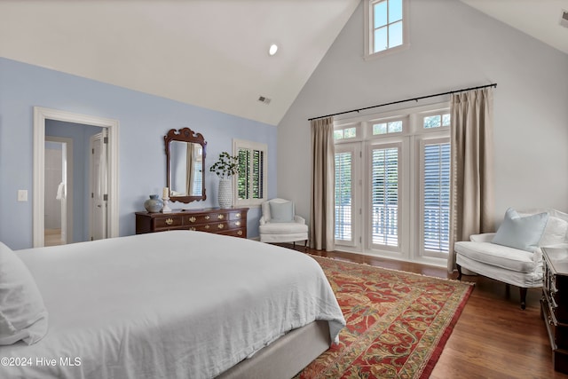 bedroom featuring dark hardwood / wood-style floors, high vaulted ceiling, and multiple windows