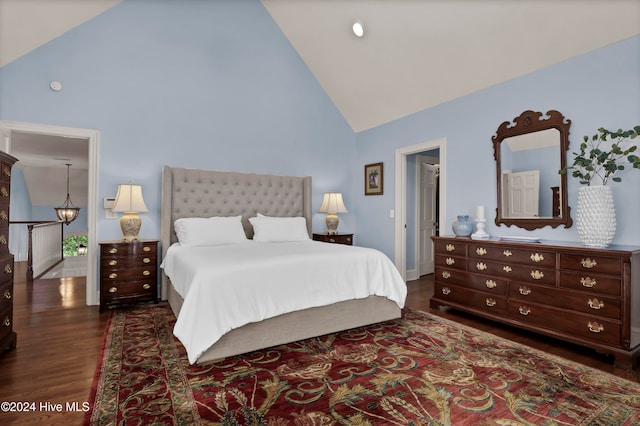 bedroom featuring dark hardwood / wood-style flooring and high vaulted ceiling