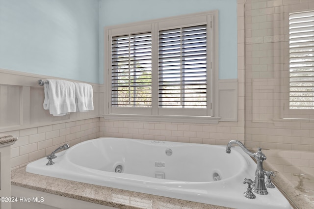 bathroom with a tub to relax in