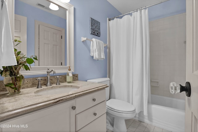 full bathroom featuring tile patterned floors, shower / bath combo with shower curtain, vanity, and toilet