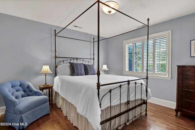 bedroom with dark wood-type flooring