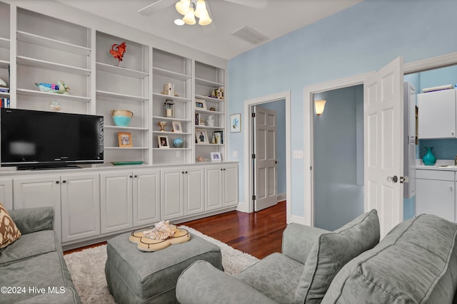 living room with ceiling fan and dark hardwood / wood-style flooring