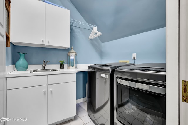 washroom with light tile patterned flooring, cabinets, independent washer and dryer, and sink