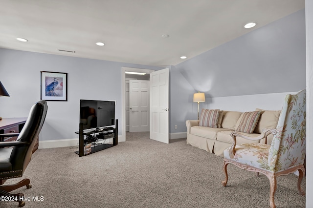 carpeted living room with vaulted ceiling