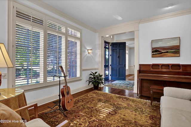 entrance foyer featuring crown molding and dark hardwood / wood-style flooring