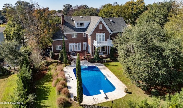 rear view of property with a lawn, a patio, and french doors