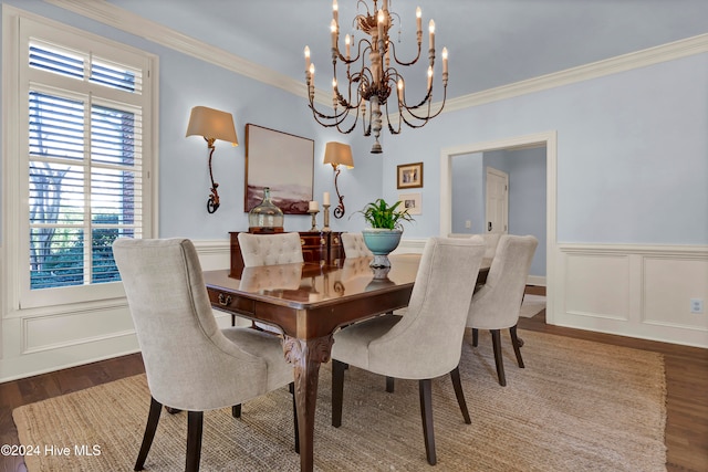 dining room featuring ornamental molding, dark wood-type flooring, and a chandelier