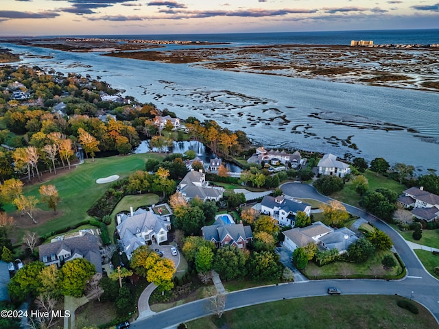 aerial view at dusk with a water view