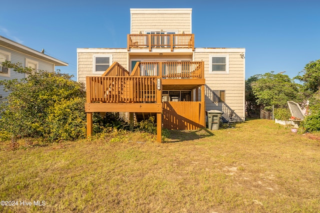 rear view of property with a lawn and a wooden deck