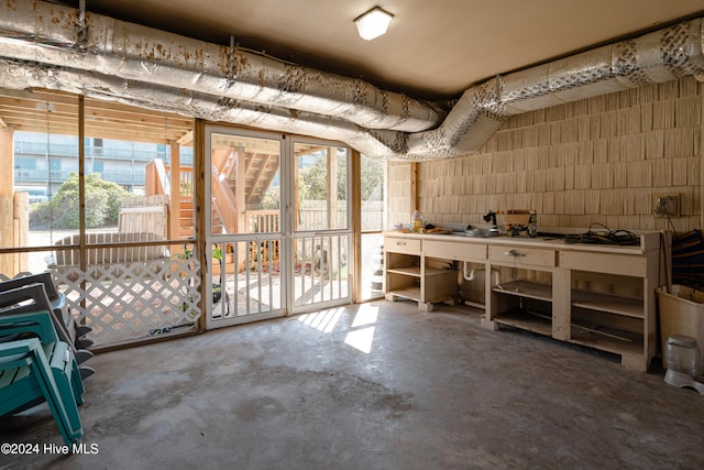 miscellaneous room featuring a workshop area and concrete floors