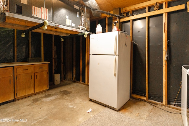 basement featuring white refrigerator