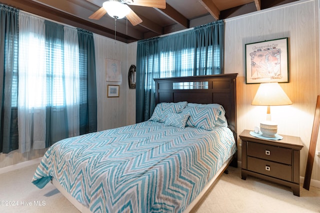 714 Ocean Blvd, Topsail Beach, NC 28445 - carpeted bedroom with beamed ceiling, wood walls, and a ceiling fan